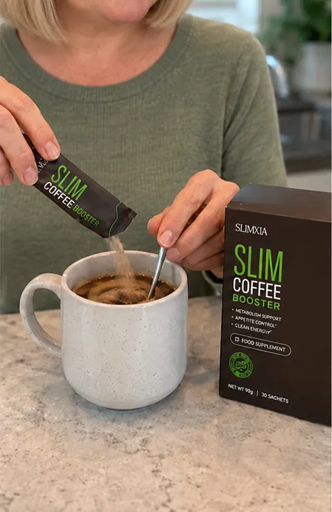 Pouring Slim Coffee Booster into a mug of coffee and stirring